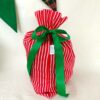 Red stripe reusable fabric gift bag. The Party Godmother Christmas party supplies.