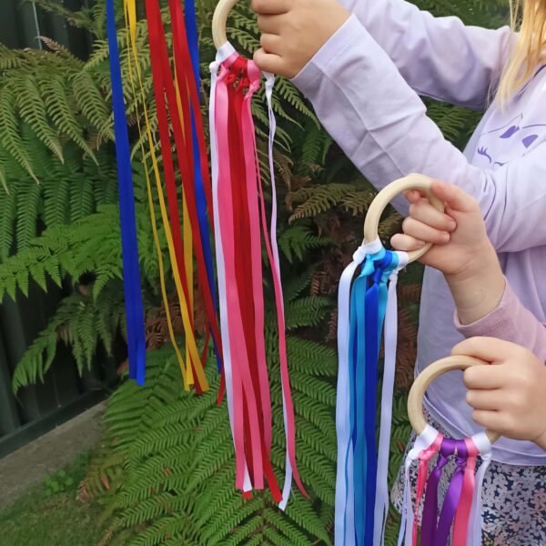 Wooden rings with satin ribbons attached The Party Godmother