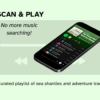 The page is a light mint green. The image is of a phone lying down with a Spotify playlist showing pirate themed songs. The text reads: Scan and Play. No more music searching! A curated playlist of sea shanties and adventurous tracks. A light gray Spotify play functions are lightly seen in the background.
