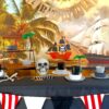 A pirate party table set up with black table cloth, skeletons, gold and plates